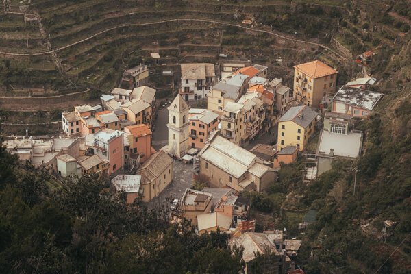 Looking down over the rooftops of Manarola from the trail above, terraced hillsides surrounding the village