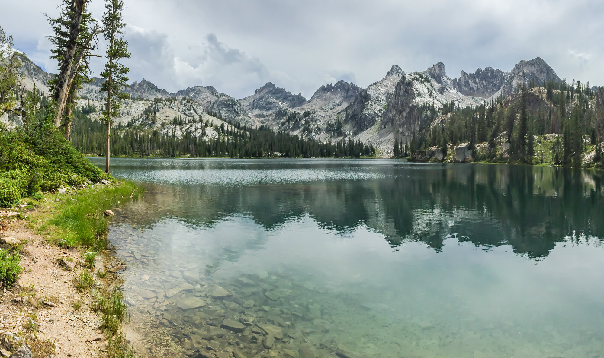 The impossibly clear water of Lake Alice with the Sawtooth peaks reflected on the surface